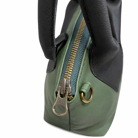 Side view of Sage green lambskin leather crossbody showing 4 inch depth and structured shape
