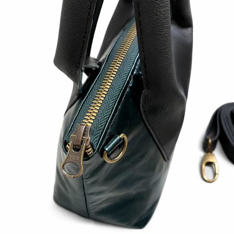 Side view of emerald teal lambskin leather crossbody showing 4 inch depth and structured shape