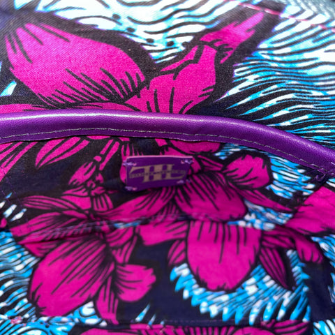 Close-up of a blue and magenta floral-patterned lining with a slip pocket and Inspired Leather Co Label