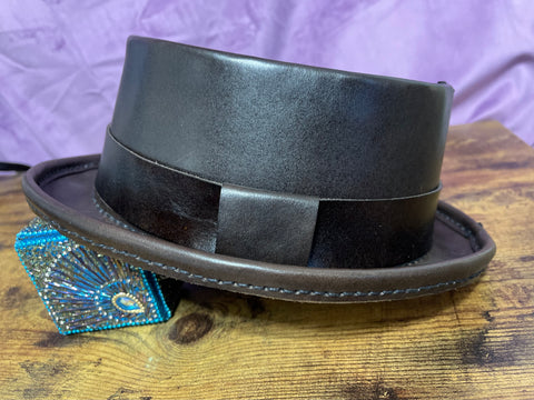 Dark Brown Pork Pie Hat against a purple backdrop