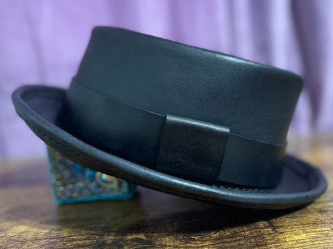 Black leather pork pie hat with a purple back drop