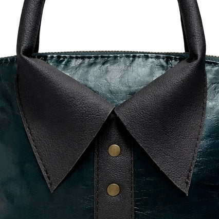 Close up of rolled leather handles and brass stud collar detail on lambskin bag