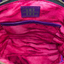 Interior of hot pink lambskin collar bag showing hot pink cotton lining, interior slip pocket, and embossed Inspired Leather Co. brand label