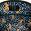 Interior of lambskin crossbody bag showing cotton lining, zipper pocket and slip pocket