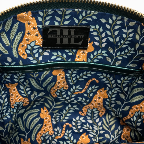 Interior of lambskin crossbody bag showing cotton lining, zipper pocket and slip pocket