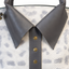 Close up of gray collar and button details on a white background