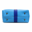 Bottom of sky blue crossbody bag showing 4 brass purse feet and royal blue center stripe