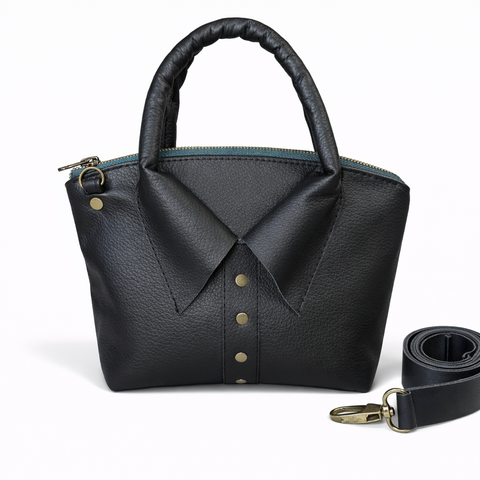 Handmade black pebbled leather collar bag with rolled top handle, antique brass studs, and detachable adjustable crossbody strap