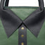 Close up of rolled leather handles and brass stud collar detail on lambskin bag