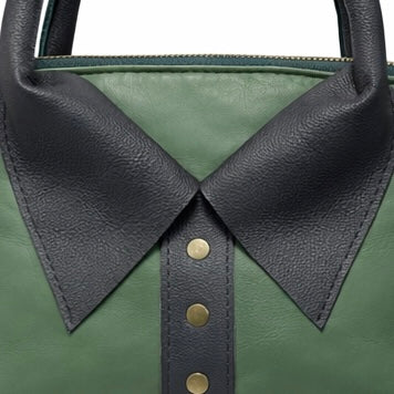 Close up of rolled leather handles and brass stud collar detail on lambskin bag