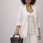 Handmade black pebbled cowhide collar bag with rolled top handle, held by model — Inspired Leather Co.