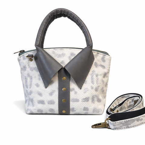 White snake embossed leather crossbody bag with gray lambskin collar and rolled handles showing python print texture and brass studs